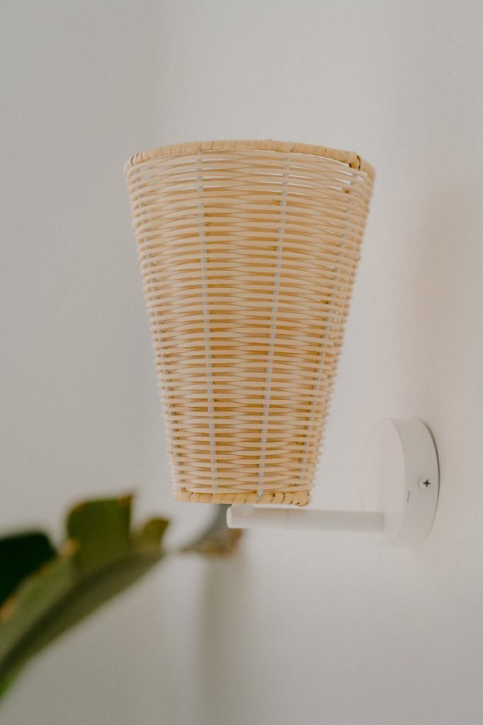 Handcrafted Costa Wall Lamp Cone Rattan with a natural rattan cone shade and white accents.