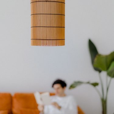 Handmade FOC Suspended Lamp M in cherry bamboo with black thread, featuring a white inner shade for ambient lighting.