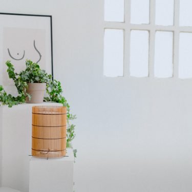 Foc Table Lamp with cherry-colored bamboo shade and black metal feet.