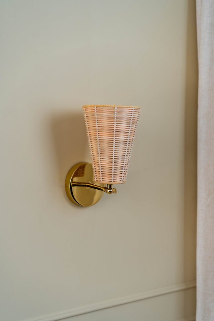 Handcrafted Costa Wall Lamp Cone Rattan/Brass with a natural rattan cone shade and brass accents.