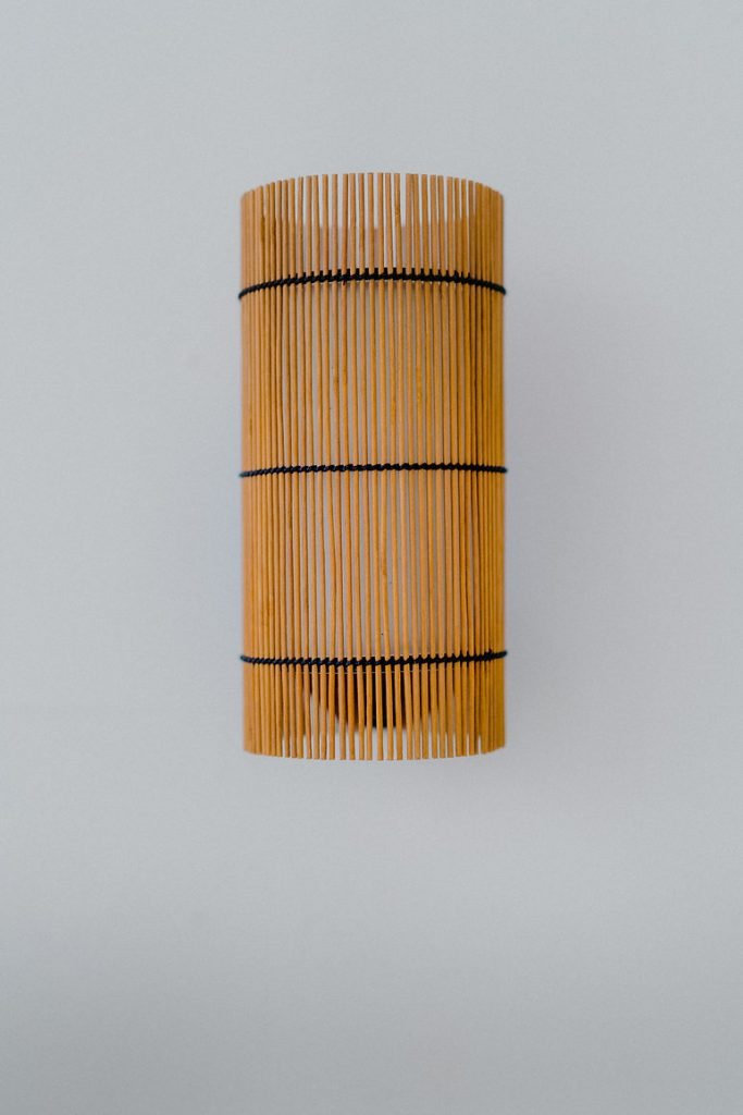 Handmade FOC Wall Lamp in cherry bamboo with black thread, featuring a white interior shade for warm light.