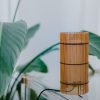 Foc Table Lamp with cherry-colored bamboo shade and black metal feet.