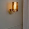 Handcrafted SUA Wall Sconce Lamp S with MDF wood slats and brass, featuring dual shades for warm light.