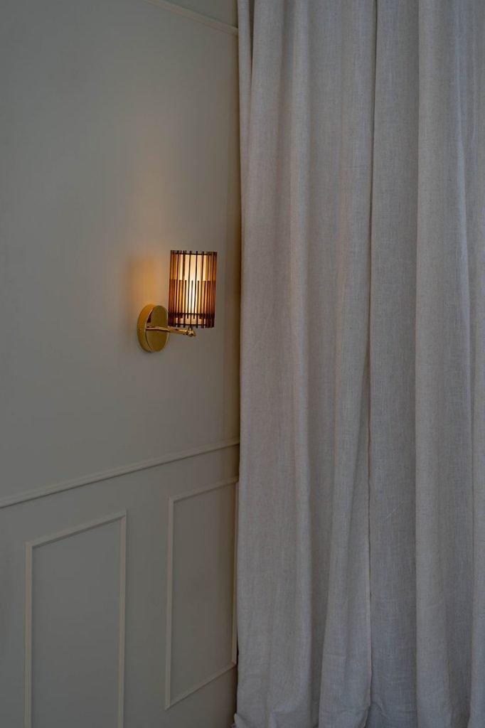 Handcrafted SUA Wall Sconce Lamp S with MDF wood slats and brass, featuring dual shades for warm light.