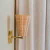 Handcrafted Costa Wall Lamp Cone Rattan/Brass with a natural rattan cone shade and brass accents.