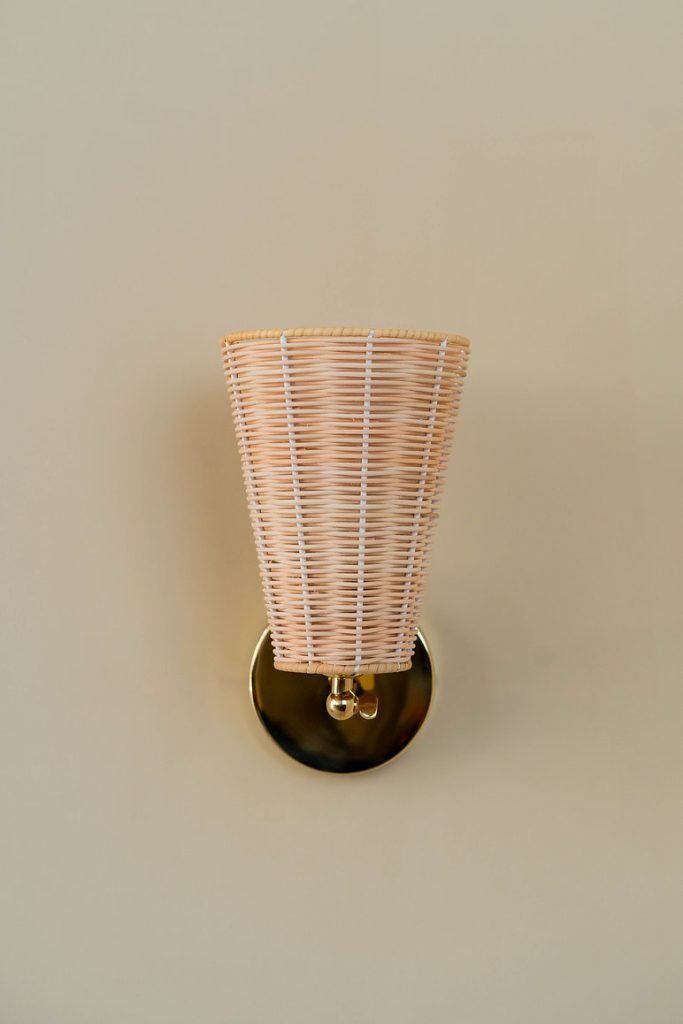 Handcrafted Costa Wall Lamp Cone Rattan/Brass with a natural rattan cone shade and brass accents.