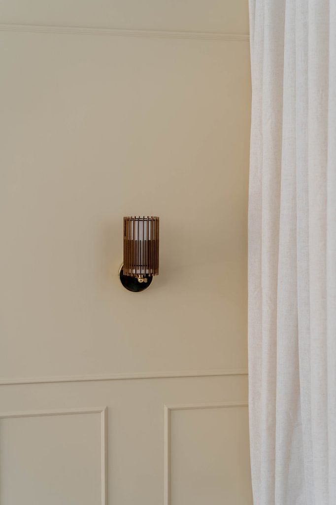 Handcrafted SUA Wall Sconce Lamp S with MDF wood slats and brass, featuring dual shades for warm light.