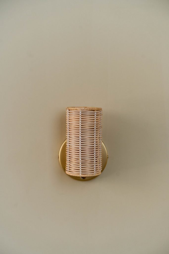 Handcrafted Costa Wall Lamp Mini Rattan Brass with natural rattan cylindrical shade.