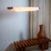 Handmade pendant lamp with white fabric shade, teak wood, and brass details