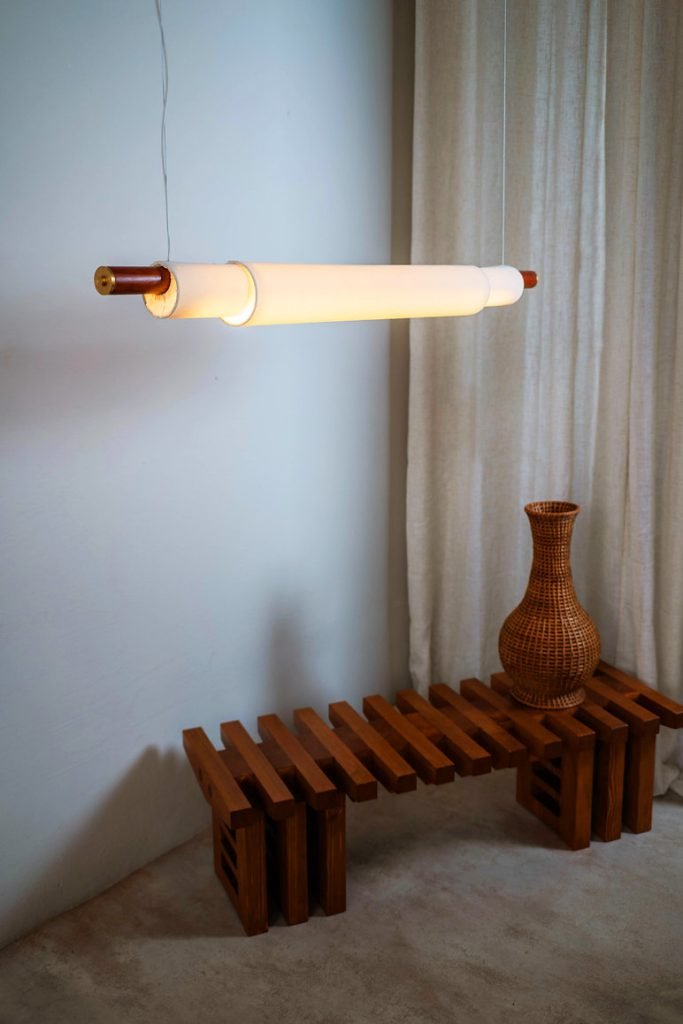 Handmade pendant lamp with white fabric shade, teak wood, and brass details