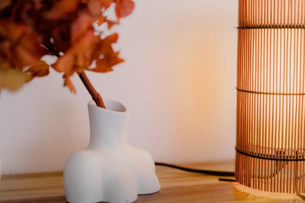 Foc Table Lamp with cherry-colored bamboo shade and black metal feet.